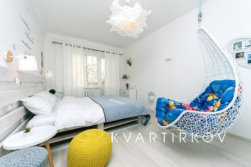 The apartment is decorated in Scandinavian style, filled wit